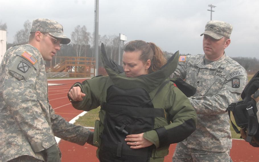 Sgt. Stephanie Beachley of the 702nd EOD suits up for her attempt to set a world record for a one-mile run in a bomb suit on March 31, 2012, in Grafenwoehr, Germany. Beachley would later finish with a time of 13 minutes, 14 seconds, which she expects to be recognized by the Guinness Book of World Records.