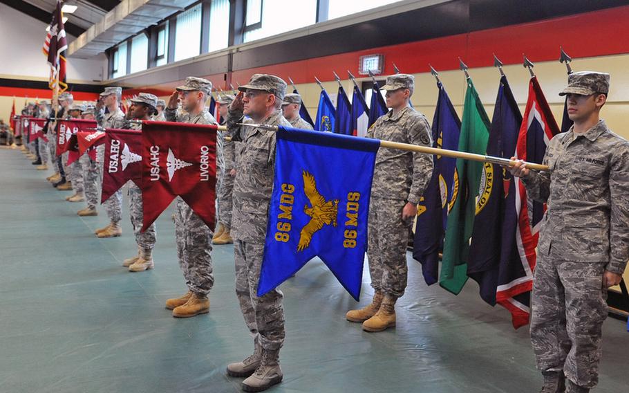 Units participating in the Landstuhl Regional Medical Center&#39;s change of command ceremony salute during presentation and honors at the ceremony where Col. Jeffrey B. Clark relinquished command to Col. Barbara R. Holcomb.