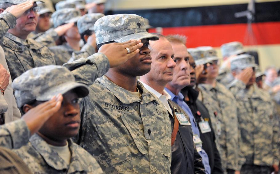 Servicemembers and civilians listen to the German and American national anthems at the Landstuhl Regional Medical Center change of command ceremony Thursday. Col. Jeffrey B. Clark relinquished command of LRMC to Col. Barbara R. Holcomb.