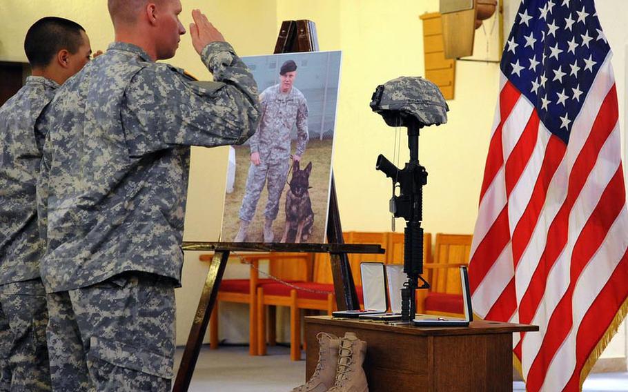 Soldiers give a final salute to Staff Sgt. Dick A. Lee Jr. at the end of the memorial ceremony for the 529th Military Police Company soldier who was killed in Afghanistan on April 26, 2012.