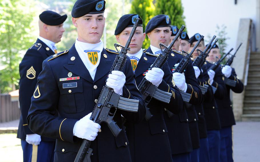 Members of the firing detail stand ready to fire salute volleys for Staff Sgt. Dick A. Lee Jr. at the memorial ceremony for the 529th Military Police Company soldier who was killed in Afghanistan on April 26, 2012.