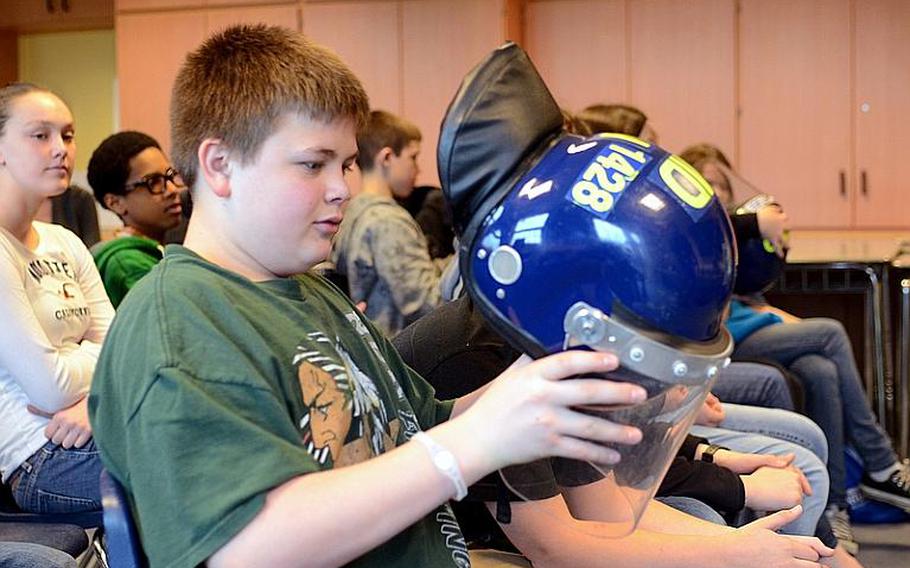 Lakenheath Middle School student Michael Landvick studies a tactical U.K. police helmet during the school?s sixth annual U.K. Day, held Friday at the school at RAF Feltwell, England. More than 50 British presenters held hour-long historical and modern-day demonstrations for the school?s sixth-, seventh- and eighth-graders.