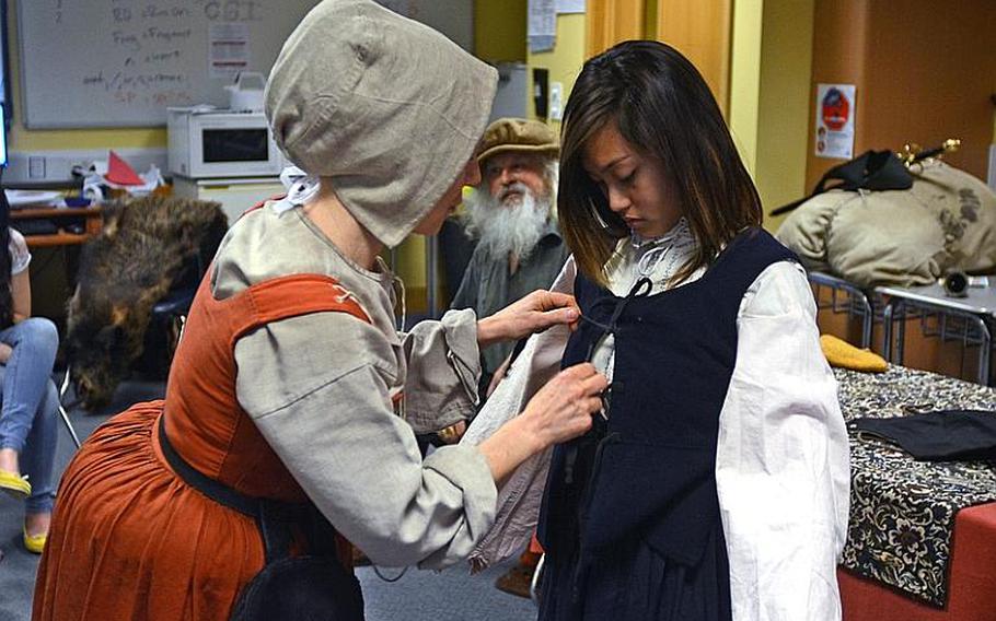 Lakenheath Middle School student Nikka Jiao dresses up in traditional Tudor clothing during the school?s sixth annual U.K. Day, held Friday at RAF Feltwell, England. More than 50 British presenters held hour-long demonstrations on Britain&#39;s history for the school?s sixth-, seventh- and eighth-graders. Modern-day Britain was also represented, with police exhibits.