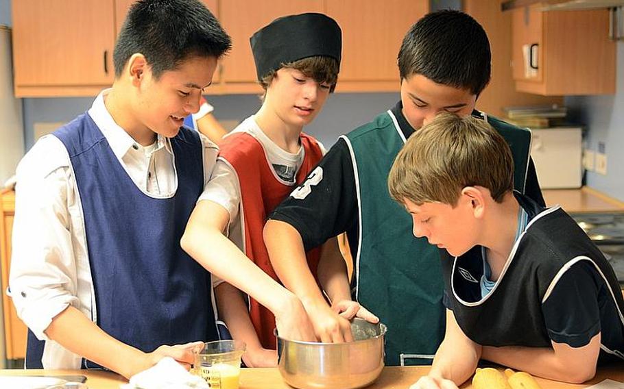 Seventh-graders from Lakenheath Middle School learn how to make traditional British scones during the school?s annual U.K. Day, held Friday at RAF Feltwell, England. Pictured from left are: Monti Azur, Jaime Hall, John Sedlack and Logan Stacy.