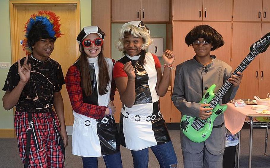 Seventh-graders dress up for Lakenheath Middle School?s annual U.K. Day, on Friday at RAF Feltwell, England. From left are: Lamont Atkins, Daniela Clark-Murrieta, Skye Bucknert and Cameron DeBose. Dressed as a 1980s punk-rocker, 1960s swinging girls and as a member of The Beatles, the students were also celebrating the Queen?s Diamond Jubilee in June, which marks Queen Elizabeth II&#39;s 60-year reign.