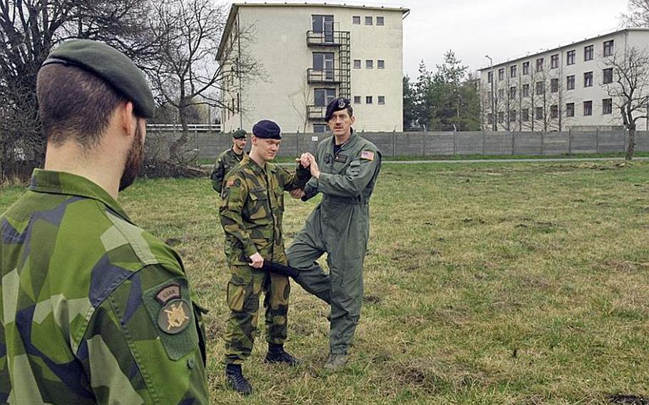 Master Sgt. Frank Prebble gives instruction to Swedish and Norwegian members of the Heavy Airlift Wing's Raven Team. The Ravens are the security element for the C-17 crew, securing the areas around the plane upon landing. Most of the training, however, focuses on communication skills and using "verbal judo" to resolve disputes that may occur in potentially hostile places.