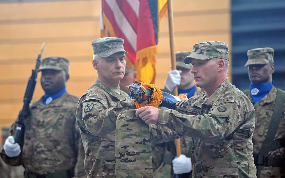 Lt. Gen. James L. Terry, V Corps commander, left, and Command Sgt. Maj. William M. Johnson case the V Corps colors at a ceremony at Wiesbaden Army Airfield, Germany, on Thursday. The corps is headed for an Afghanistan deployment and is leaving Germany for good after more than 60 years.