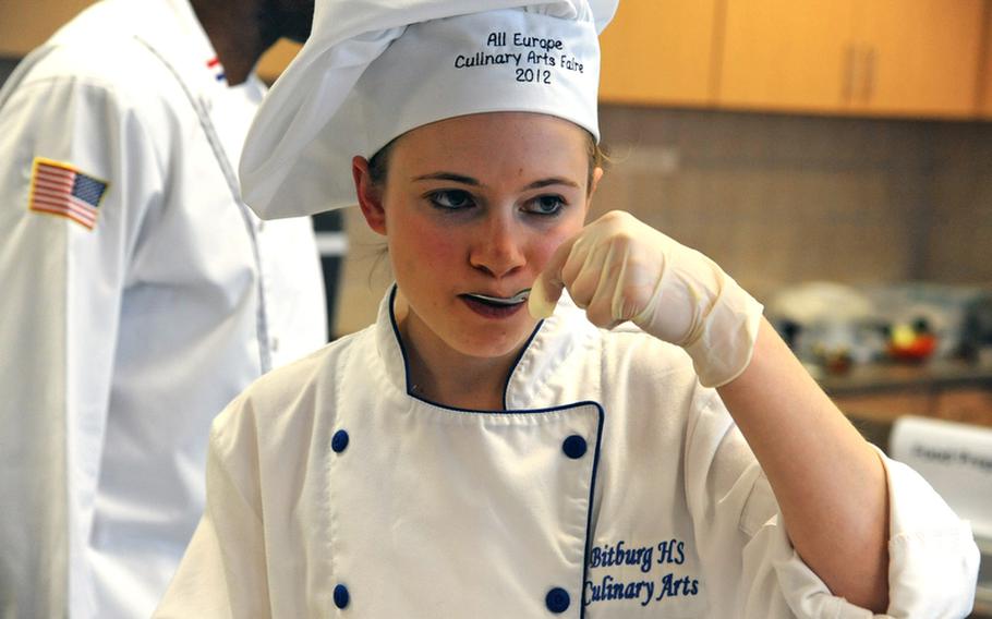 Bitburg&#39;s Kaitlyn Miller tastes one of her team&#39;s dishes during the cooking competition at the DODDS-Europe Culinary Arts Faire in Sembach, Germany, Wednesday.