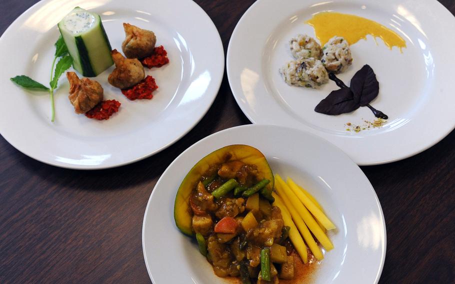 Bitburg&#39;s entry in the cooking competition was, counter clockwise from top left, vegetable samosas with red chili pepper chutney, chicken mango curry and indian rice pudding. The cooks were Cheyenne Pillatzke, Yveth Murillo and Kaitlyn Miller.