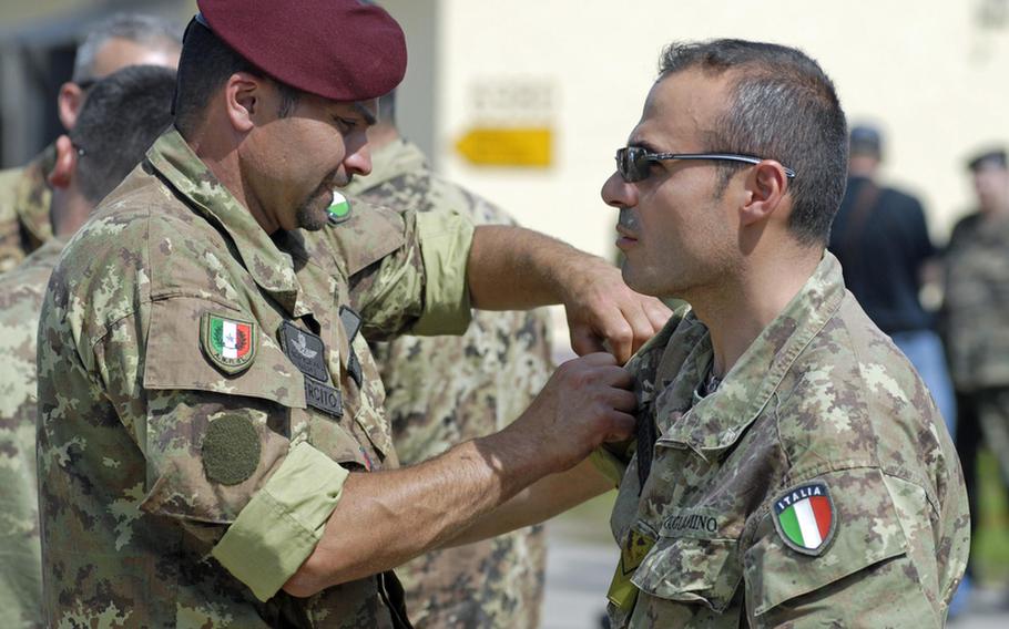 A pair of Italian soldiers get their uniforms squared away during the 29th annual Monte Kali Pokal shooting competition at the Wackernheim Regional Range complex, near Wiesbaden.