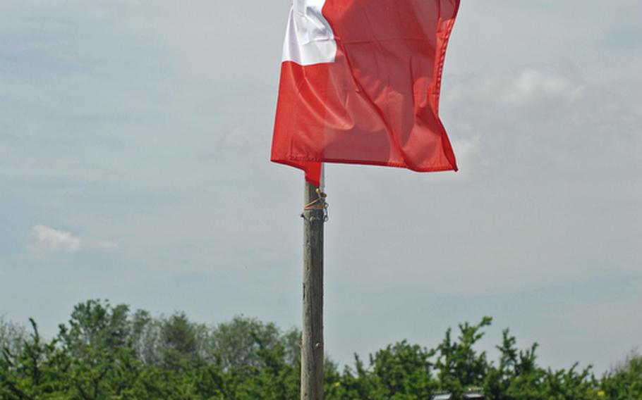 Switzerland&#39;s flag flies above a tent area for Swiss soldiers on Friday at the 29th annual Monte Kali Pokal shooting competition at the Wackernheim Regional Range complex, near Wiesbaden. The Swiss SIG SG 550 was the featured weapon during the three-day competition.
