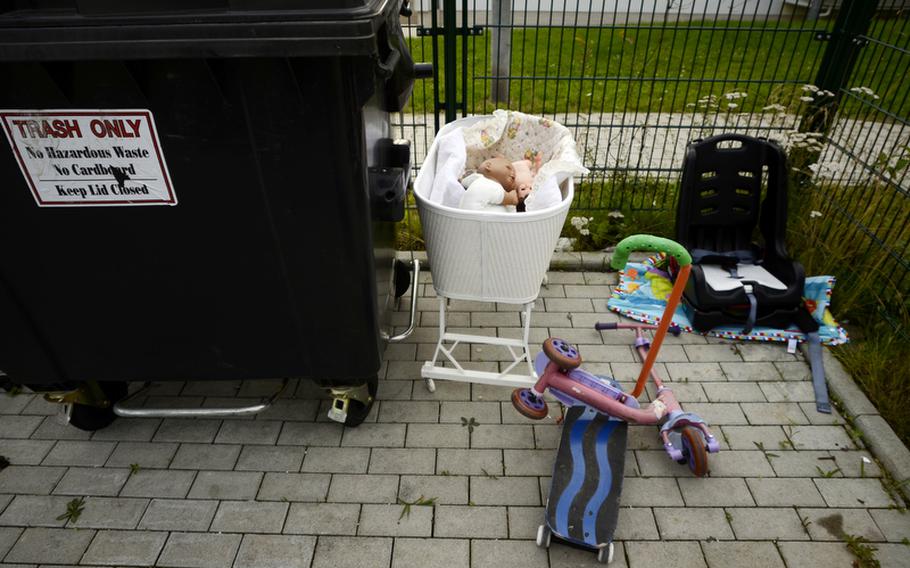 Soldiers with the 170th Infantry Brigade Combat Team and their families leave behind unwanted possessions as they depart Baumholder, Germany.