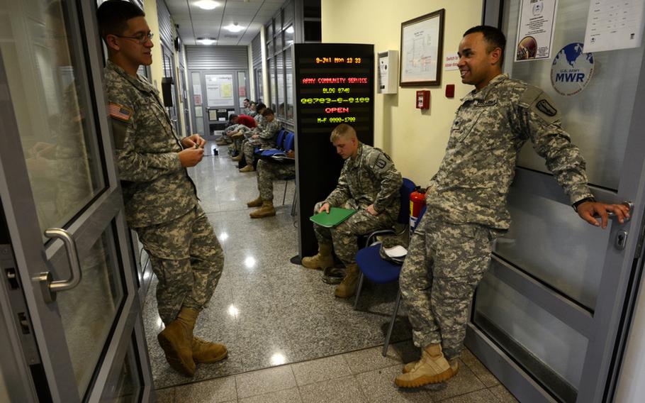 Soldiers with the 170th Infantry Brigade Combat Team wait outside the scheduled airlines ticket office on Smith Barracks, Baumholder, Germany, to get travel arrangements as the 170th is scheduled to inactivate later this fall.