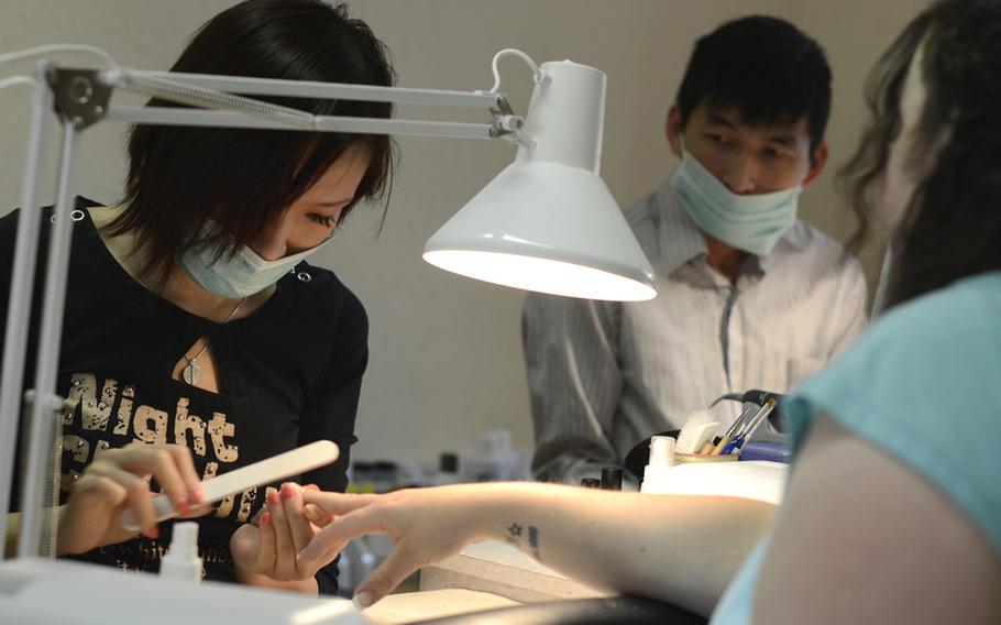 Trang Vu and her husband Mai Hien own and operate USA Nails in Baumholder, Germany. USA Nails does a lot of business with Americans and Hien says the shop won’t survive if the base closes.