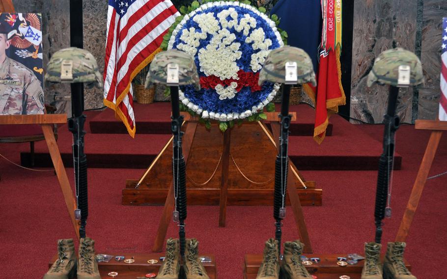 Helmets, rifles and boots representing Spc. Theodore Matthew Glende, Spc. Justin Louis Horsley, Pfc. Adam C. Ross and Spc. Brenden Neal Salazar are displayed in the front of the post chapel at Caserma Ederle in Vicenza, Italy, shortly after a Thursday memorial service for the four soldiers from the 173rd Airborne Brigade Combat Team.