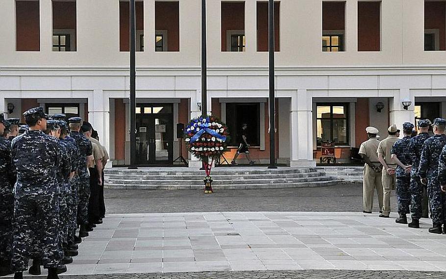 A memorial wreath stands in honor of victims of the Sept. 11, 2001, terrorist attacks in the United States as servicemembers and others in Naples, Italy, attend a ceremony of remembrance Sept. 11, 2012, at the Capodichino base.