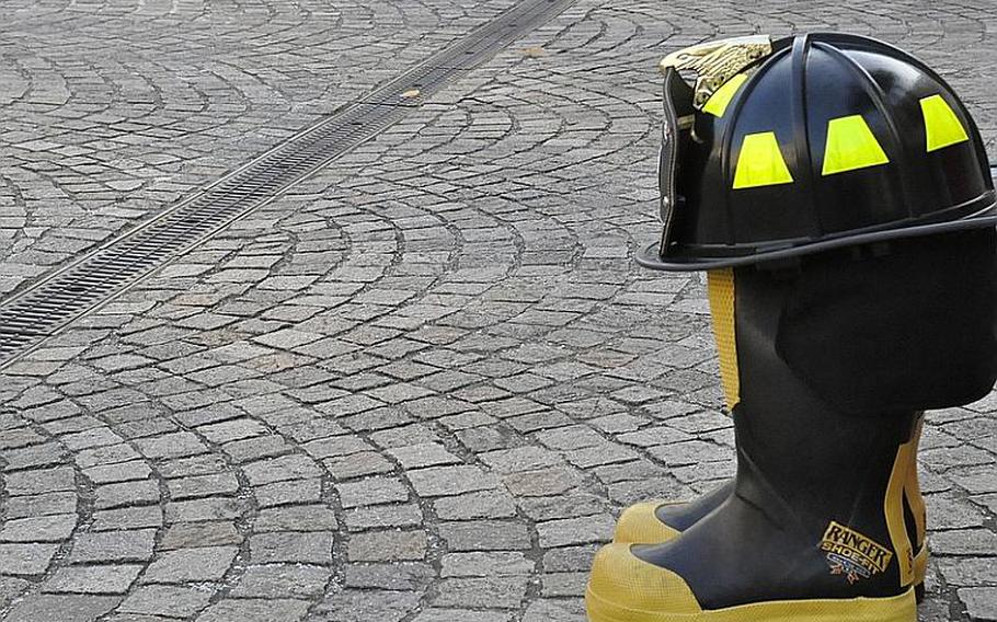 A pair of boots represents the victims of the Sept. 11, 2001, terrorist attacks in the United States during a memorial service at the Capodichino base of Naval Support Activity Naples, Italy. More than 200 people attended Tuesday&#39;s service, which featured band music, invocations and a moment of silence for the victims.