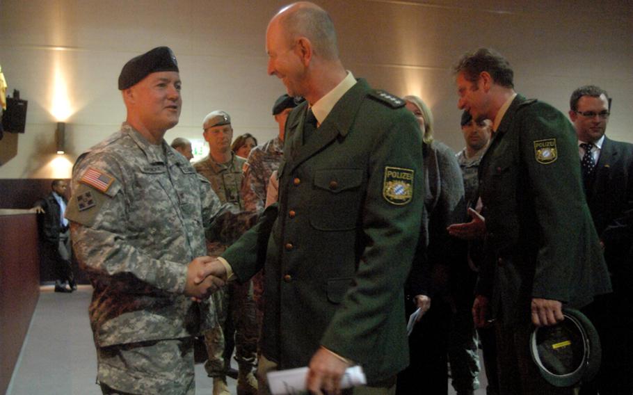 Col. Jeffrey R. Martindale, outgoing commander of the Joint Multinational Readiness Center, greets guests after he relinquished command of the maneuver training center during a ceremony in Hohenfels, Germany on Sept. 19, 2012. Martindale said the assignment was his last before he retires from the Army.
