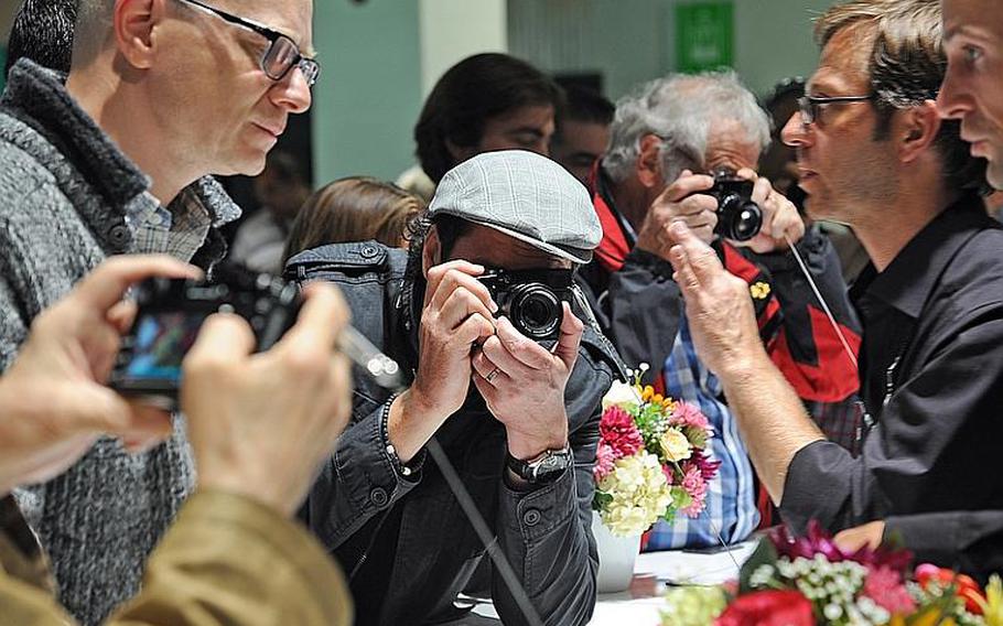 Photographers check out new digital cameras Wednesday at the Fuji stand during Photokina in Cologne, Germany. Photokina, at the city's fairgrounds, is billed as the largest imaging trade fair in the world. It is open through Sept. 23, 2012, from 10 a.m. to 6 p.m. Admission is 45 euros, but on Saturday and Sunday family tickets are available for 47 euros for two adults and two children ages 7 to 17.