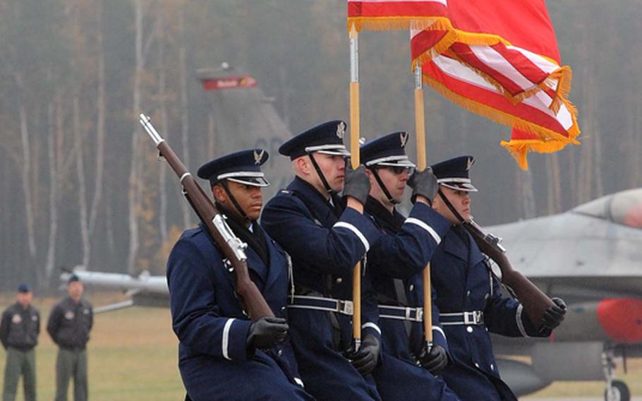 The Spangdahlem Air Base color guard marches off the field at the conclusion of the activation ceremony for Detachment 1, 52nd Operations Group in Lask, Poland, Friday.