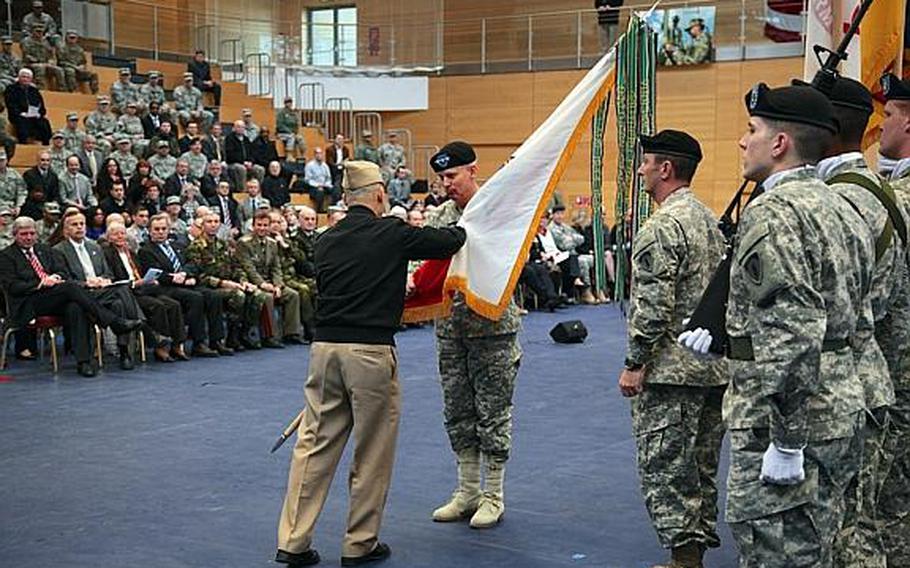 Adm. James Stavridis, commander of U.S. European Command and Supreme Allied Commander Europe, hands the U.S. Army Europe colors to Lt. Gen. James M. Campbell Jr., who assumed command of USAREUR during a ceremony Wednesday at Wiesbaden's Clay Kaserne. 