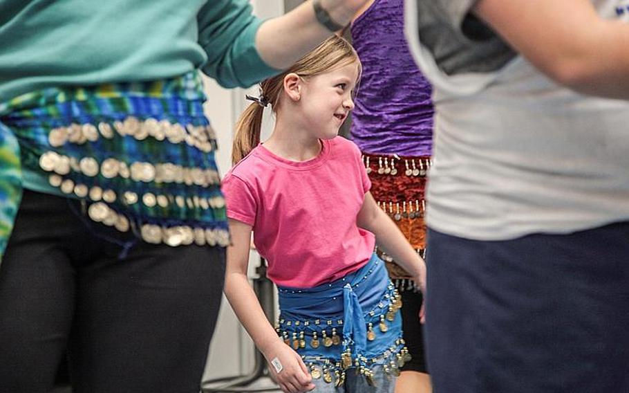 Emma Butterfield, 5, takes part in a FemFusion fitness class that was part of a family wellness night at Landstuhl Elementary-Middle School. For two hours, most of the school was overrun with students and family members engaged in everything from Double Dutch jumping rope to making their own sushi to spinal screenings. Nearly 60 activities and informational sessions were part of the event, which received help from local military units and organizations and a handful of off-base businesses, including Brianne Grogan's FemFusion Fitness.
