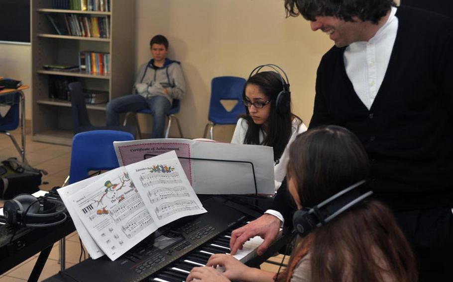 Italian pianist Davide Franceschetti helps out Katherine Sibilla, an eighth-grader at Vicenza Middle School who is learning to play the piano. The 36-year-old concert pianist performed for students in Vicenza and visited a few classrooms in an effort to promote classical music.