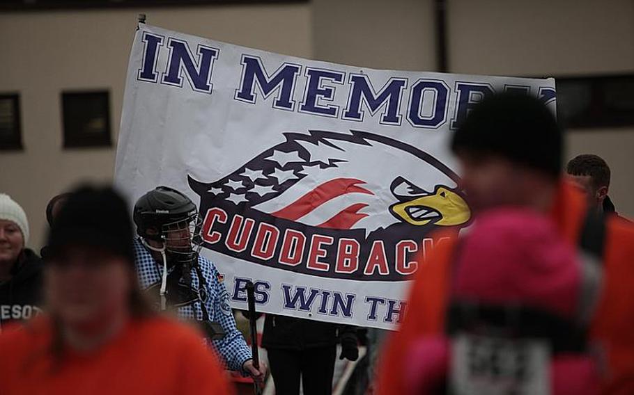 Members of the Kaiserslautern Millitary Community Eagles hockey team carry a banner in memory of Airman 1st Class Zachary Cuddeback during a memorial run and walk Saturday. Cuddeback was one of two airmen slain March 2, 2011, when a gunman attacked a group of airmen at Frankfurt Airport.
