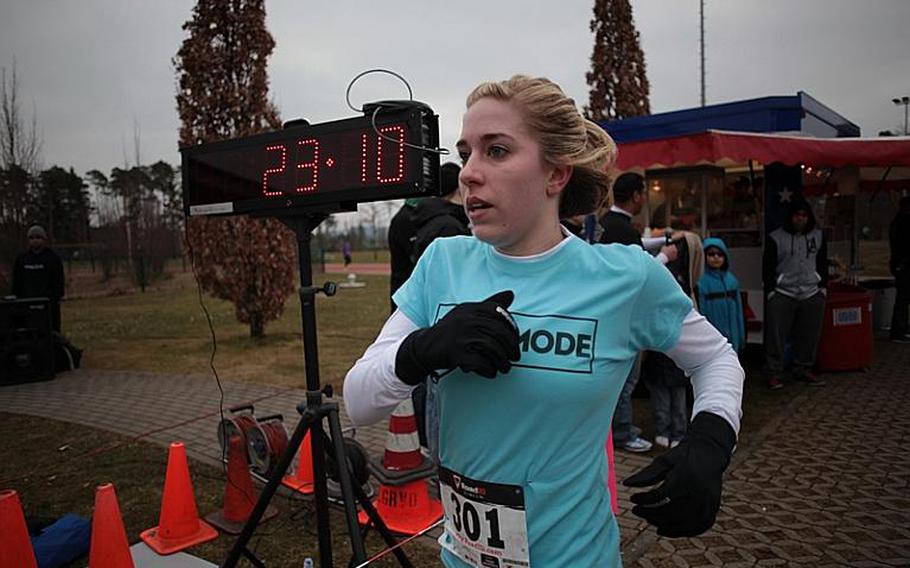 Devin Adams crosses the finish line in just over 23 minutes Saturday to take third place overall for women in the Zac Cuddeback Memorial 5k. The run was in tribute to Cuddeback, one of two airmen killed by a lone gunman at Frankfurt Airport on March 2, 2011.