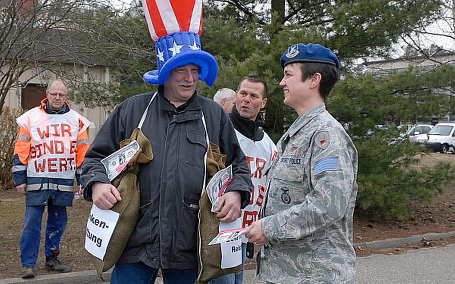 Michael Gebhardt, a member of the union representing German civilians who work on U.S. bases and an employee with the 86th Security Forces Squadron, chats with Marina Mueller, a fellow union member and security police officer, during a protest April 3, 2013, on Ramstein Air Base. A wage increase that the German employees were lobbying for in April was agreed to on Friday, June14, 2013.