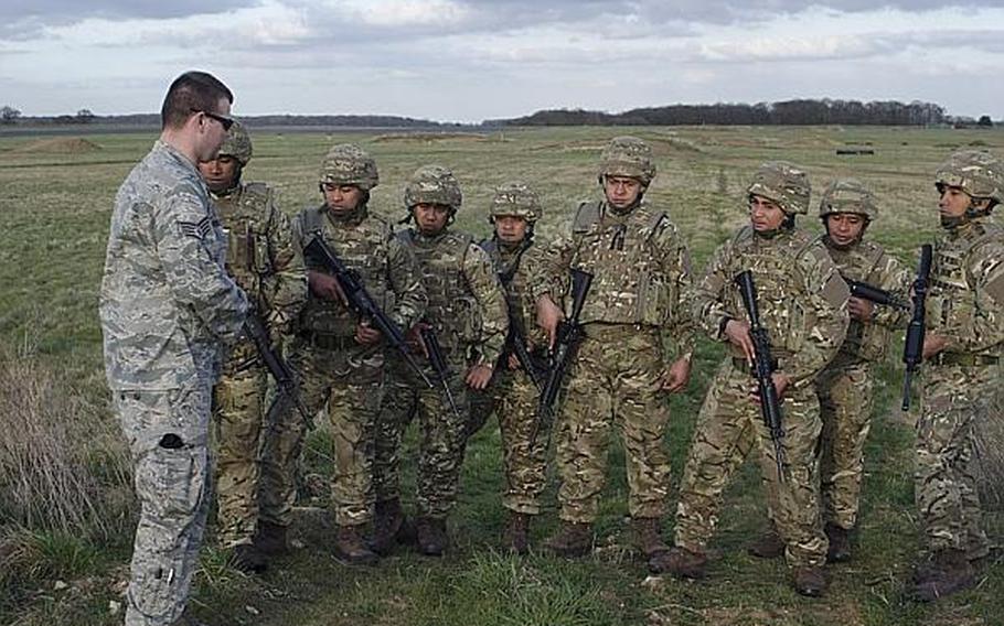 U.S. Air Force Staff Sgt. John Houston with the 100th Security Forces Squadron from RAF Mildenhall, closes a training session on military dog familiarization with members of the 6th Contingent of the Tonga Defense Services at RAF Honington on April 15, 2013. The sixth group of Tongans to go to Afghanistan, they will deploy to Camp Bastion in Afghanistan and assist British and U.S. forces with base security.

Adam L. Mathis/Stars and Stripes