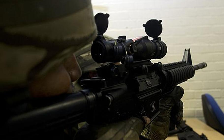 Pvt. Paula Fonoifua with the Tonga Defense Services' 6th Contingent, looks through an Advanced Combat Optical Gunsight during a class taught by U.S. airmen at RAF Honington on April 15, 2013. The airmen helped trained the Tongans at the request of the British military, who are putting the Tongans through eight weeks of training before they deploy to Afghanistan.

Adam L. Mathis/Stars and Stripes