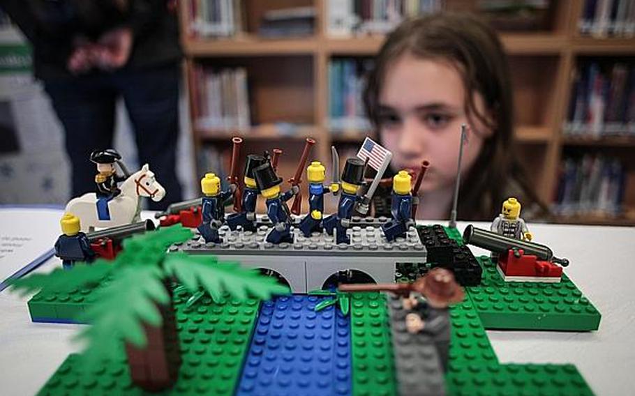 Raelin Bretzke, 9, examines a Lego construction depicting Burnside's Bridge, which played a major role in the Civil War Battle of Antietam. Confederate soldiers held the bridge for several hours before Union soldiers, led by Maj. Gen. Ambrose Burnside, seized it. Ripken Stork, an eighth-grader at Landstuhl Elementary/Middle School, built the model as part of his class' examination of the war. For their projects, other students looked at various aspects of the war, such as weaponry, diseases and major battles.
