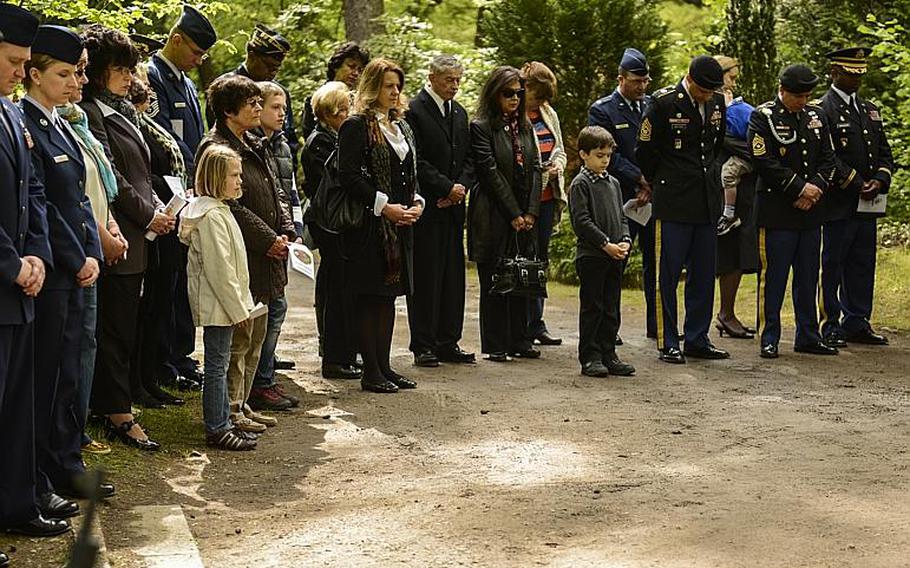 Distinguished visitors and guests bow their heads during a prayer at the annual Kindergraves memorial service May 18, 2013, at the main cemetery in Kaiserslautern, Germany. 

