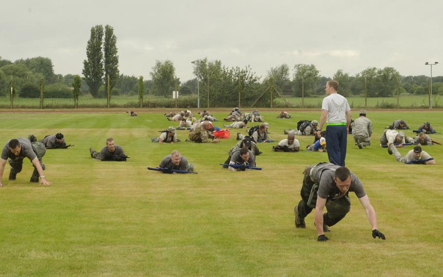 Once reaching a certain point on the course, airmen participating in the Monster Mash could move across the field in a "bear crawl," using their hands and feet. The competition was part of a 10-event course covering more than seven miles on RAF Mildenhall, England, on Wednesday, July 3, 2013.