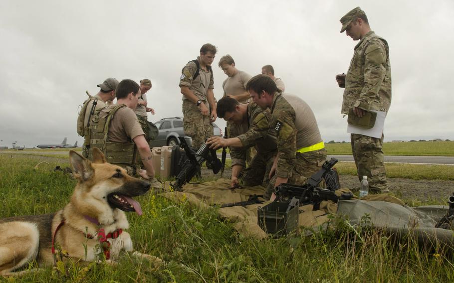 Members of a Monster Mash team attempt to assemble three common military weapons at RAF Mildenhall on Wednesday, July 3, 2013. Each weapon was worth five points and failure to assemble a weapon properly would hurt the team's standing against its competitors.