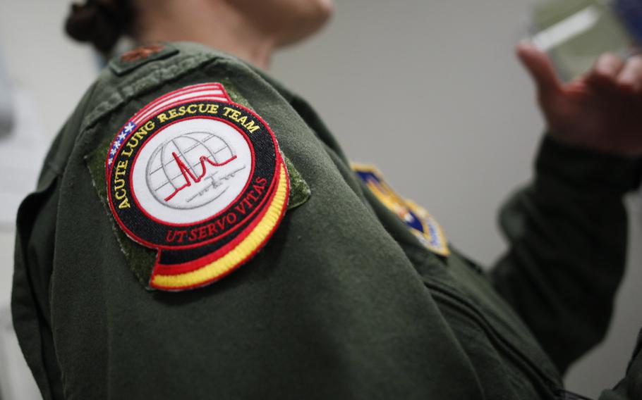 U.S. Air Force Maj. Michelle Langdon, lead registered nurse on the Acute Lung Rescue Team and Critical Care Air Transport Team, speaks with personnel at Landstuhl Regional Medical Center, Germany. The ALRT on July 10, 2013, aided in the the longest-known move of a patient on extracorporeal membrane oxygenation treatment, flying her from Ramstein, Germany, to San Antonio Military Medical Center, Texas.