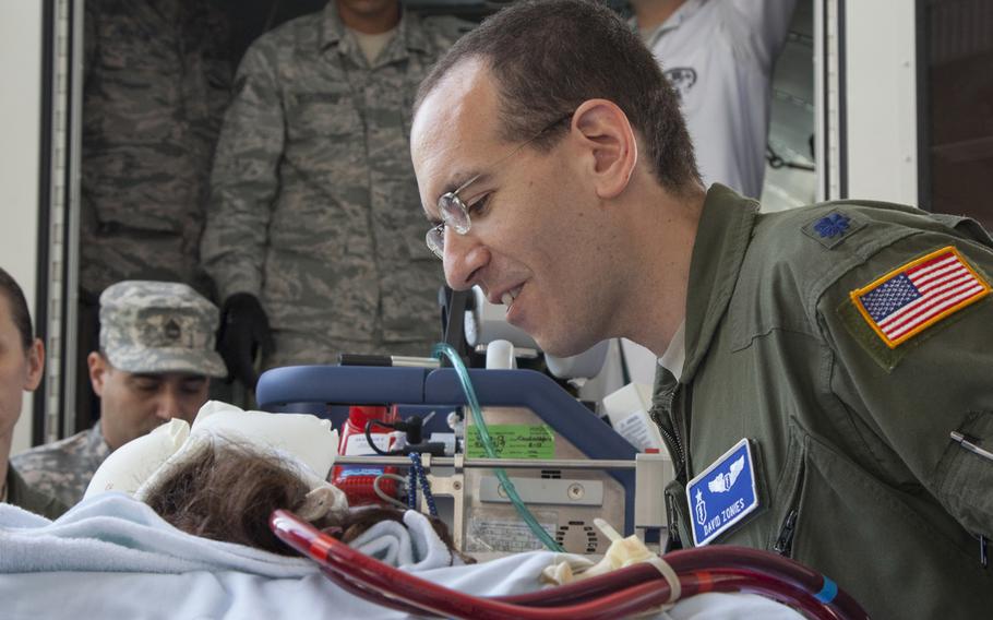 U.S. Air Force Lt. Col. David Zonies, chief of trauma and critical care at Landstuhl Regional Medical Center and head of U.S. Air Forces in Europe's Acute Lung Rescue Team, speaks with a patient on extracorporeal membrane oxygenation treatment before she was transferred from Landstuhl Regional Medical Center, Germany to the San Antonio Military Medical Center, Texas. This was the first time the military moved an ECMO patient over such a distance.