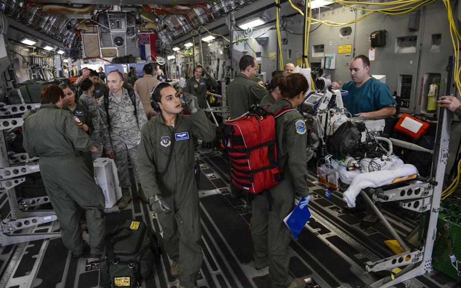 Medical personnel with the Acute Lung Rescue Team load a patient on extracorporeal membrane oxygenation treatment onto a C-17 Globemaster III on Ramstein Air Base, Germany, for a flight to the San Antonio Military Medical Center, Texas. This will be the first time the military will have moved an ECMO patient over such a distance.