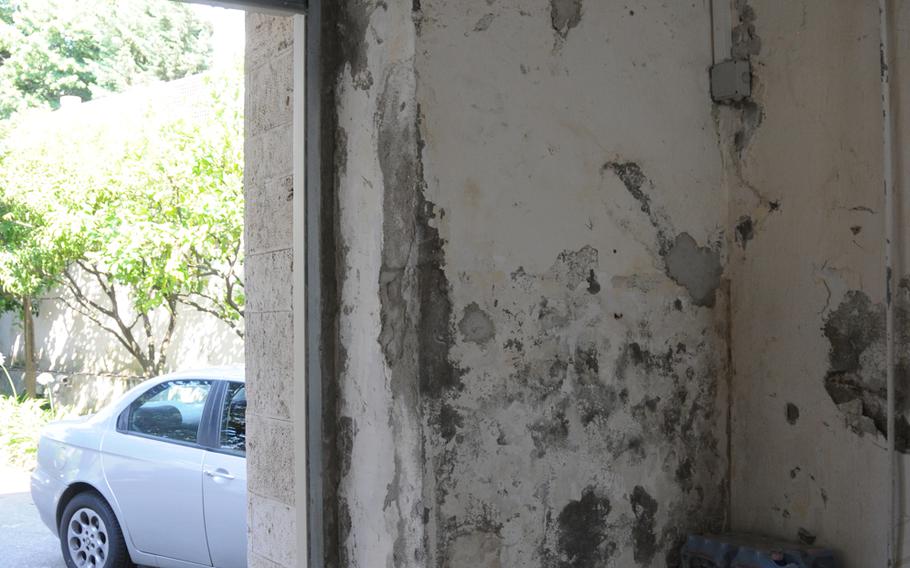 Water damage and erosion, possibly caused by exposure to salt water in the atmosphere, is evident in the garage area of Villa Nike.