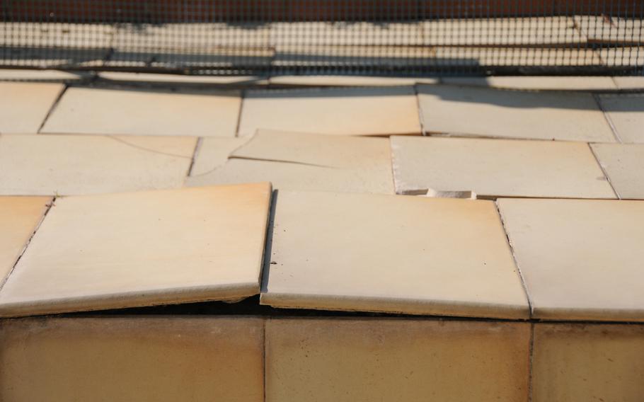 Many tiles on the patio and around the pool at Villa Nike have cracked or buckled. Engineers are trying to determine whether the villa might be "slipping" off the Naples hill on which it sits, or if the property is "settling" and thus causing the tiles and walls to crack.