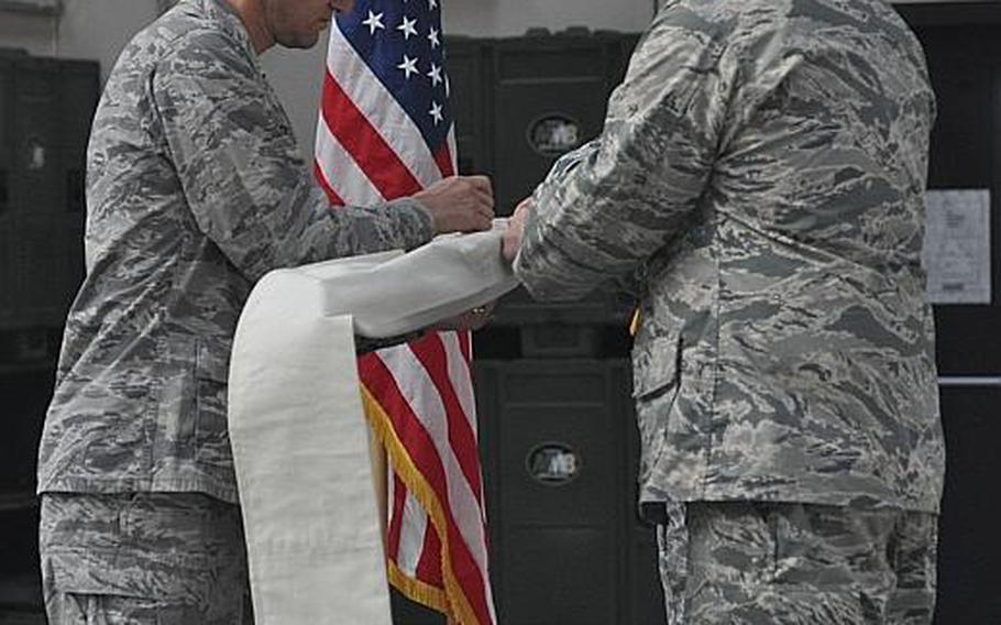 Col. Anthony D. Abernathy, left, commander of the 31st Fighter Wing's Operation Group, and Lt. Col. Stephen V. Carocci, commander of the 603rd Air Control Squadron, case the 603rd's guidon on Aug. 29, 2013, during an inactivation ceremony at Aviano Air Base, Italy.
