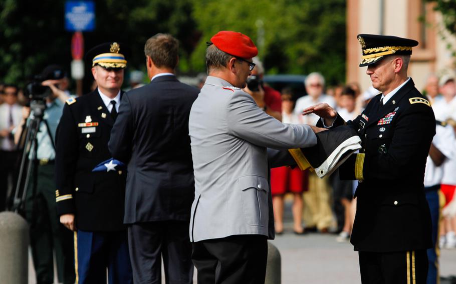 German Col. Wolfgang Mika hands the last German flag flown at the Army's Campbell Barracks in Heidelberg to Lt. Gen. Donald M. Campbell Jr., the commander of U.S. Army Europe. Behind then, garrison commander Col. Brian DeCoster hands the last American flag flown here to Heidelberg Mayor Eckart Wuerzner. Until earlier this year, the base was USAREUR's headquarters. A number of bases in the city will soon be handed over to German authorities, ending the American presence here after almost seven decades.