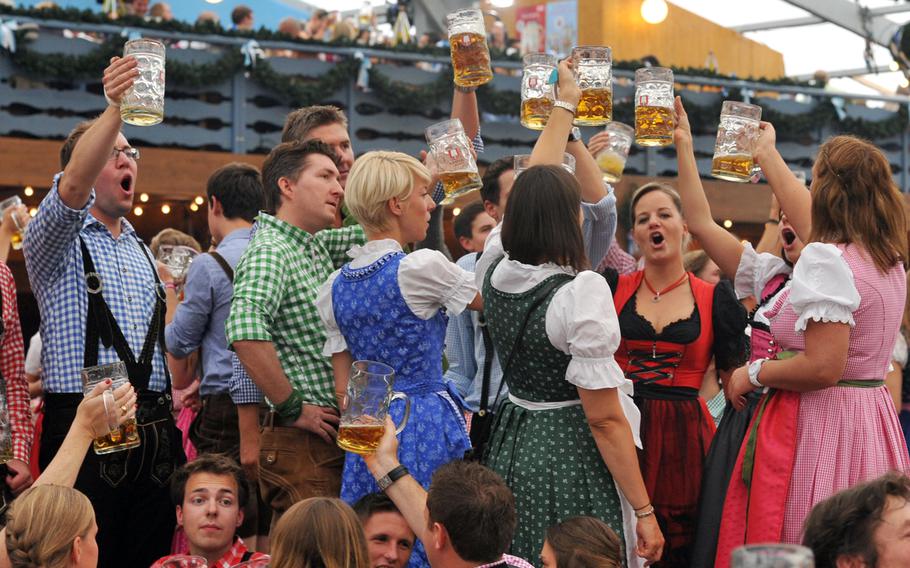 Prosit! Revelers toast the opening of the 180th Oktoberfest in Munich, Saturday, Sept. 21, v2013.