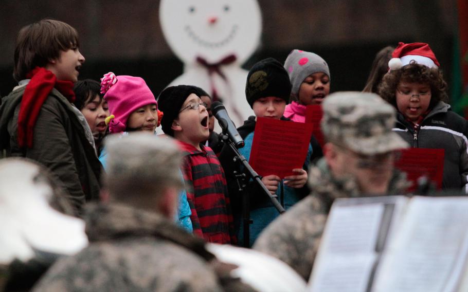 Students from Kaiserslautern Elementary School sing holiday carols at the 21st Theater Sustainment Command's tree lighting ceremony Wednesday, Dec. 4, 2013, at Panzer Kaserne in Kaiserslautern, Germany.