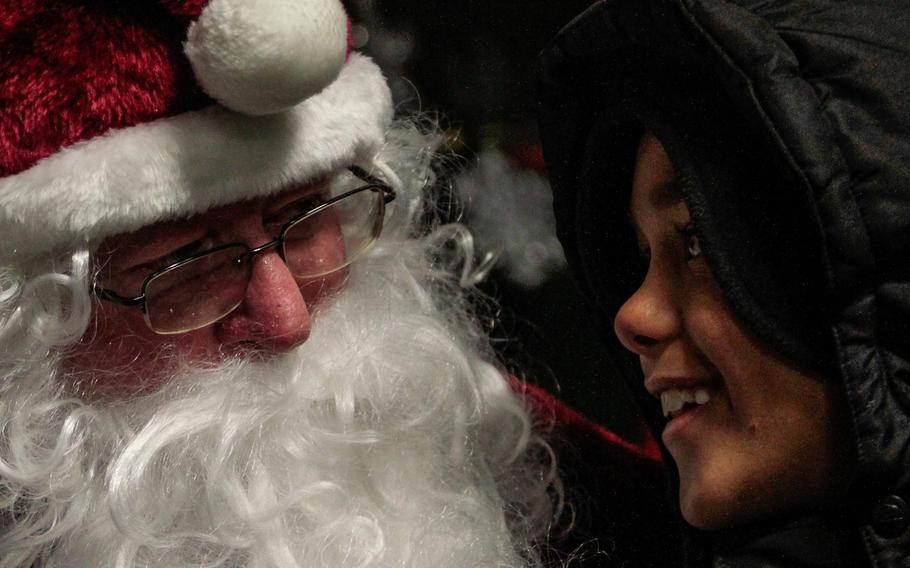 Justice Warren, 8, talks with Santa at the 21st Theater Sustainment Command's holiday tree lighting ceremony Wednesday, Dec. 4, 2013, at Panzer Kaserne in Kaiserslautern, Germany.