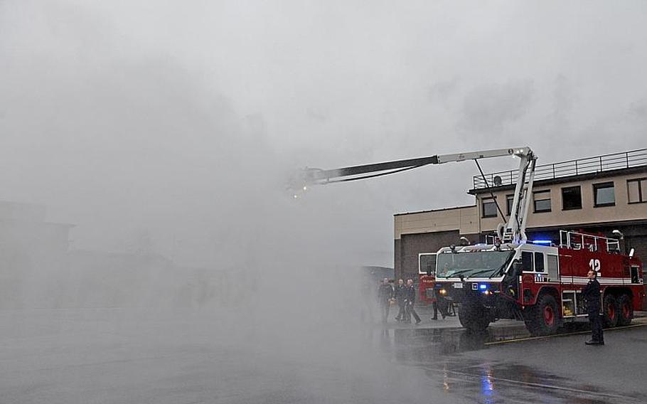 A firetruck at Ramstein Air Base, Germany, sprays water in a demonstration for visiting German soldiers from the 8th Kompanie, Spezialpionierbatallion 464 on Thursday, Feb. 13, 2014. The soldiers visited the air base to familiarize themselves with U.S. Air Force C-130 aircraft and American firefighting equipment.
