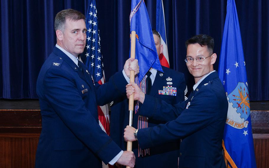 Lt. Col. Matthew Olson, right, assumes command of the 422nd Communications Squadron from Col. Charles Hamilton, left, 422nd Air Base Group commander at RAF Croughton, England, on July 8, 2013. Olson and Hamilton were relieved of their commands on Thursday after an investigation raised questions about their abilities.