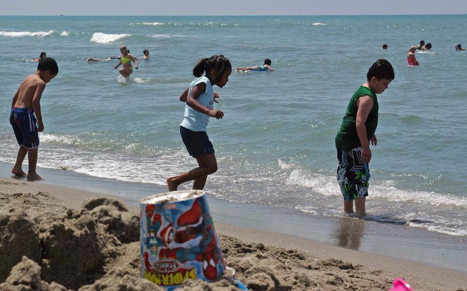 Kids from the school at nearby Camp Darby hit the American Beach in Tirrenia, Italy.