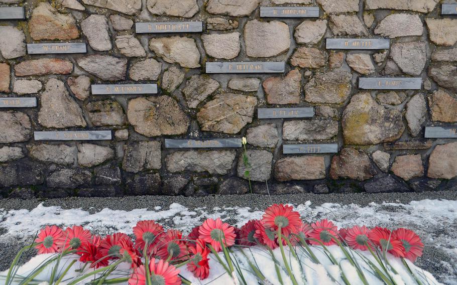 Flowers left by school children lie in front of the Malady Massacre Memorial following a ceremony marking the 70th anniversary of the Malady massacre Sunday, Dec. 14, 2014. On Dec.17, 1944, in Baugnez, Belgium, Nazi SS troops killed 84 American prisoners of war during the Battle of the Bulge. Baugnez is a suburb of Malmedy.